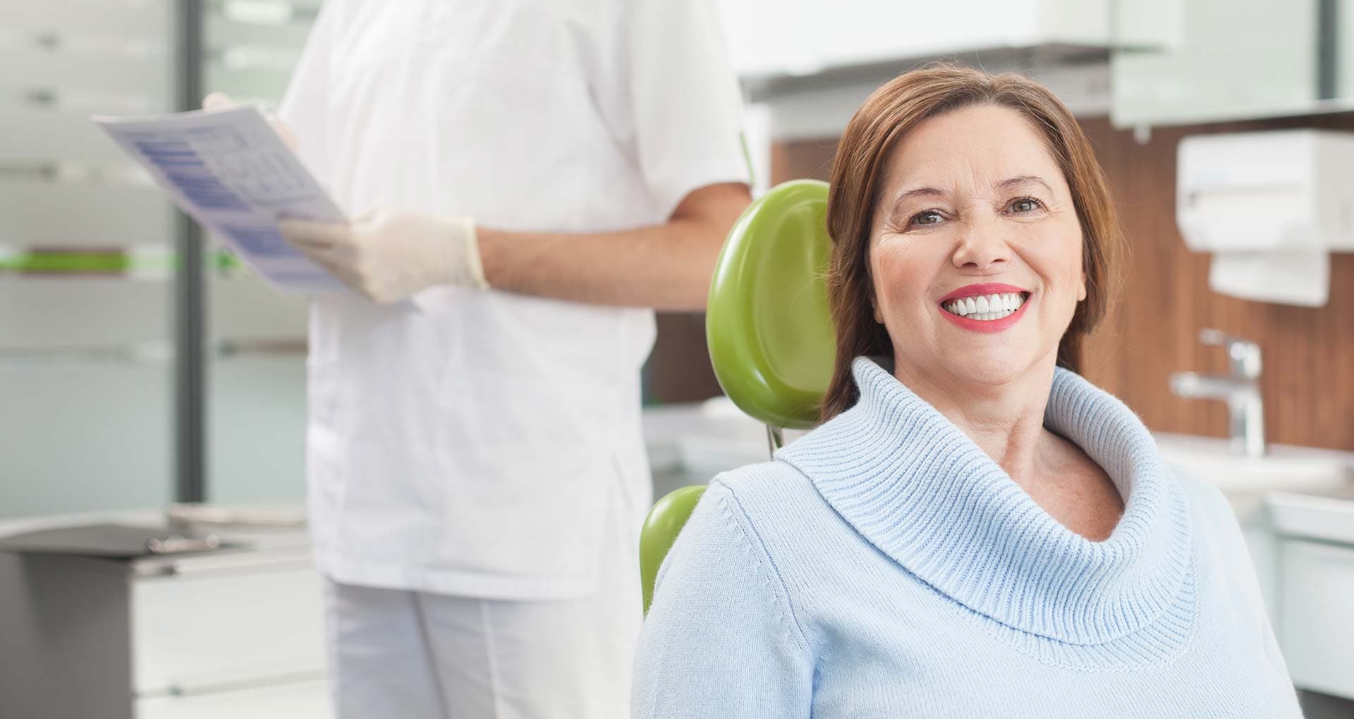 Patient consulting with periodontist about dental implant candidacy
